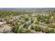 Aerial view showcasing the neighborhood with tree lined streets and nearby shopping area at 6382 W Byers Pl, Lakewood, CO 80226