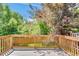 Outdoor deck area with wood railings offering a view of the backyard at 6382 W Byers Pl, Lakewood, CO 80226