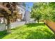 A view of a well-maintained backyard with a fence and greenery at 6382 W Byers Pl, Lakewood, CO 80226