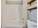 The bright white bathroom features a clean design with a shower/tub combination and open shelving at 6382 W Byers Pl, Lakewood, CO 80226
