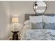 Bedroom with a gray headboard, decorative pillows, and a modern side table at 6382 W Byers Pl, Lakewood, CO 80226