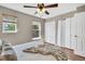 A cozy bedroom showcases a ceiling fan, bright windows, and ample closet space at 6382 W Byers Pl, Lakewood, CO 80226