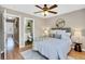 Bedroom with a queen bed, a ceiling fan, and an en-suite bathroom at 6382 W Byers Pl, Lakewood, CO 80226