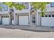 Close up exterior view of a row of townhomes, each with a garage and door entrance at 6382 W Byers Pl, Lakewood, CO 80226
