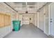 A large garage with white walls and sealed floor, additional storage and utility sink to the rear at 6382 W Byers Pl, Lakewood, CO 80226