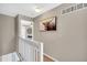 Hallway featuring a decorative painting and an open view to another room at 6382 W Byers Pl, Lakewood, CO 80226