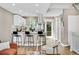Bright kitchen with stainless steel appliances, breakfast bar, and stylish stools offering a functional space at 6382 W Byers Pl, Lakewood, CO 80226