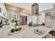Modern kitchen featuring white cabinets, stainless steel appliances, and a breakfast bar with stylish decorations at 6382 W Byers Pl, Lakewood, CO 80226
