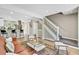Open concept living area with view of a staircase, hardwood flooring, and access to kitchen, great for entertaining at 6382 W Byers Pl, Lakewood, CO 80226