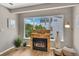 Stylish living room featuring a wood-burning fireplace, bright natural light, and a comfortable seating arrangement at 6382 W Byers Pl, Lakewood, CO 80226
