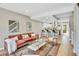 Inviting living room and kitchen combo, with hardwood floors and a cozy seating area, complete with natural light at 6382 W Byers Pl, Lakewood, CO 80226
