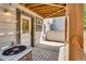 Private patio area off the back of the garage with an a/c unit and door to backyard at 6382 W Byers Pl, Lakewood, CO 80226