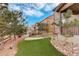 Landscaped backyard with artificial turf and fire pit at 13717 Ashgrove Cir, Parker, CO 80134