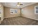 Spacious carpeted bedroom with ceiling fan and large window at 13717 Ashgrove Cir, Parker, CO 80134