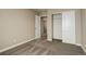 Well-lit bedroom with double door closet and access to hallway at 13717 Ashgrove Cir, Parker, CO 80134