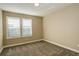 Neutral-toned bedroom with two windows and plantation shutters at 13717 Ashgrove Cir, Parker, CO 80134