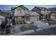 Two-story house with gray siding, stone accents, and a two-car garage at 13717 Ashgrove Cir, Parker, CO 80134