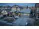 Two-story house with gray siding, stone accents, and a two-car garage at 13717 Ashgrove Cir, Parker, CO 80134