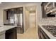 Modern kitchen with dark cabinets, stainless steel appliances, and an island at 13717 Ashgrove Cir, Parker, CO 80134