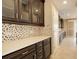 Kitchen with dark cabinets, mosaic backsplash and an abundance of counter space at 13717 Ashgrove Cir, Parker, CO 80134