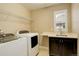 Laundry room with washer, dryer, sink, and shelving at 13717 Ashgrove Cir, Parker, CO 80134