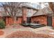 Brick home with a small back patio and deck at 1036 Lexington Ave, Westminster, CO 80023