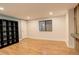 Finished basement with wood-look floors, shelving, and a window at 1036 Lexington Ave, Westminster, CO 80023