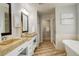 Elegant bathroom with double vanity, granite countertops, and a soaking tub at 1036 Lexington Ave, Westminster, CO 80023