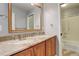 Bathroom with double vanity, granite countertop, and shower at 1036 Lexington Ave, Westminster, CO 80023