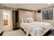 Basement bedroom with Murphy bed, neutral colors, and ensuite bathroom at 1036 Lexington Ave, Westminster, CO 80023