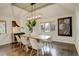 Elegant dining room with modern light fixture, light paint, and hardwood floors at 1036 Lexington Ave, Westminster, CO 80023