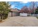 Spacious driveway leading to a three-car garage, fenced area, and partial basketball court at 1036 Lexington Ave, Westminster, CO 80023