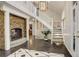 Bright entryway with dark hardwood floors and a stone fireplace at 1036 Lexington Ave, Westminster, CO 80023