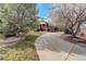 Landscaped yard with a long driveway leading to the house at 1036 Lexington Ave, Westminster, CO 80023