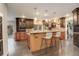 Spacious kitchen featuring breakfast bar with counter seating and dark wood cabinetry at 1036 Lexington Ave, Westminster, CO 80023