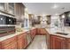 Gourmet kitchen featuring granite countertops, stainless steel appliances, and rich wood cabinets at 1036 Lexington Ave, Westminster, CO 80023