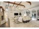 Spacious living room featuring a stone fireplace, high ceilings with beams, and modern furnishings at 1036 Lexington Ave, Westminster, CO 80023