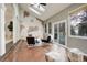 Bright living room featuring skylights, vaulted ceiling, statement wall, and sliding glass door to the backyard at 1036 Lexington Ave, Westminster, CO 80023