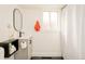 Bathroom featuring a modern vanity with black hardware, an oval mirror, and a shower with a white curtain at 2774 W Irvington Pl, Denver, CO 80219