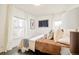 Sunlit bedroom with sleek black tile floors, large windows, and a cozy bed with decorative pillows and artwork at 2774 W Irvington Pl, Denver, CO 80219