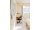 Close up on a desk in a bright bedroom with tiled floor and an artful design on the wall at 2774 W Irvington Pl, Denver, CO 80219