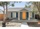 Charming home exterior with gray siding, blue shutters, a bright yellow front door, and well-maintained landscaping at 2774 W Irvington Pl, Denver, CO 80219