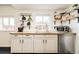 Bright kitchen with butcher block countertops, white cabinets, and open shelving for a modern touch at 2774 W Irvington Pl, Denver, CO 80219