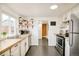 Functional kitchen with stainless steel appliances, light wood countertops, and a view into the next room at 2774 W Irvington Pl, Denver, CO 80219