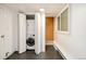 Compact laundry area featuring a stackable washer and dryer unit tucked behind folding doors at 2774 W Irvington Pl, Denver, CO 80219