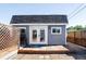 Backyard outbuilding with a gray exterior, a small deck, and double french doors at 2774 W Irvington Pl, Denver, CO 80219