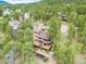 Stunning aerial view of the home nestled among lush trees, showcasing its secluded setting at 4198 Timbervale Dr, Evergreen, CO 80439