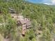 Beautiful aerial perspective of a property surrounded by dense forest, emphasizing privacy at 4198 Timbervale Dr, Evergreen, CO 80439