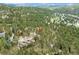 An aerial view of a wooded neighborhood showcasing the natural surroundings and scenic location at 4198 Timbervale Dr, Evergreen, CO 80439
