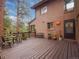 Inviting back deck with charming furniture, perfect for relaxing and enjoying the outdoors at 4198 Timbervale Dr, Evergreen, CO 80439